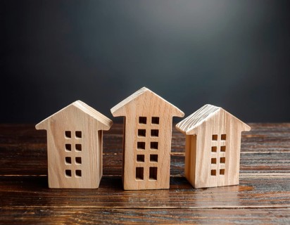 A collection of small wooden model houses with cozy lighting, creating a warm and inviting
