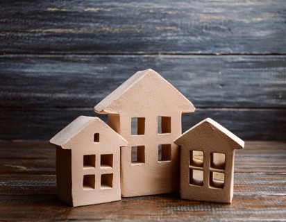 A collection of small model houses with cozy lighting, creating a warm and inviting atmosphere, AI
