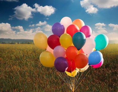 Bunch of balloons flying in the blue sky. The concept of a holiday, congratulations, gifts, events,