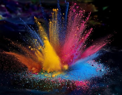 A colorful explosion powder on black background.. Multicolored powder explosion, AI generated
