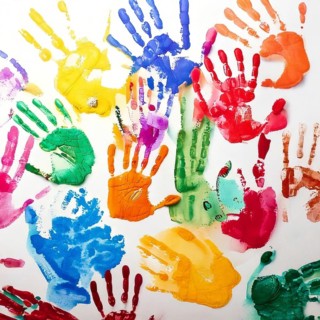 Vibrant multicolored handprints on white background, symbolizing creativity, playful expression,