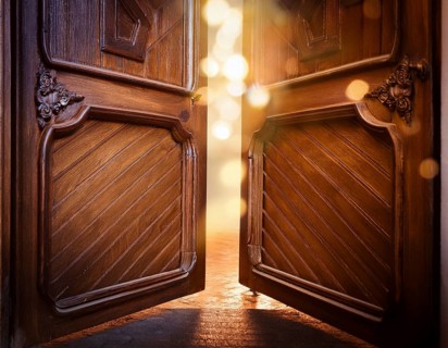 Vintage door ajar in the middle with glowing magical warm lights on the other side, AI generated