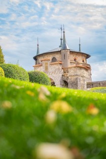 Beautiful castle with pewter towers and manicured lawns under a blue sky, Lichtenstein Castle,