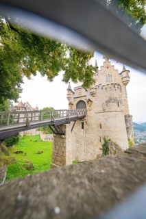 View through an opening onto a bridge leading to a castle, Lichtenstein Castle, Lichtenstein,