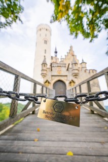 Locked chain on a bridge with a view of a castle gate, Lichtenstein Castle, Lichtenstein, Swabian