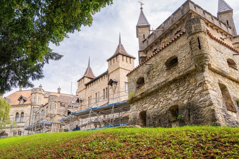 Old castle with towers and scaffolding for renovation in green surroundings, Lichtenstein Castle,