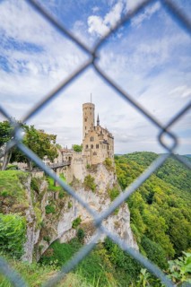 Castle on a hill seen through a lattice, surrounded by forest, Lichtenstein Castle, Lichtenstein,