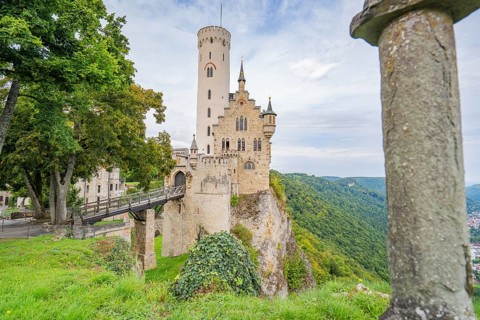 Castle majestically enthroned on a cliff, surrounded by green forest, Lichtenstein Castle,