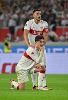 Ermedin Demirovic VfB Stuttgart (09) massages Angelo Stiller VfB Stuttgart (06) 's shoulder,