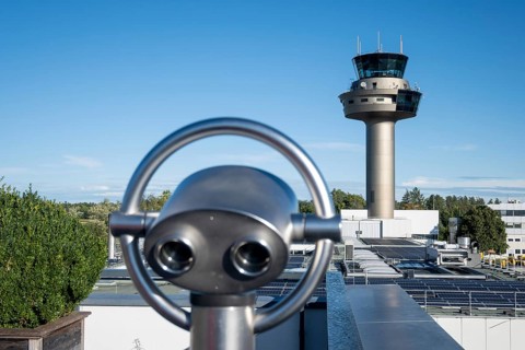 Binoculars for visitors aimed at the tower of Salzburg Airport, Austria