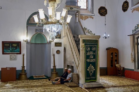 Mosque interior with seating and illuminated chandelier, Ibrahim Pasha Mosque, Old Town, Turkish