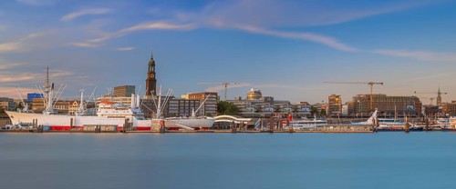 View over the Norderelbe to the main church St. Michaelis and the Landungsbrücken with ships in