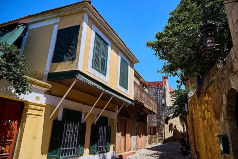 Colourful house facades with shutters in a historic alley, Turkish Quarter, Rhodes Old Town, Rhodes