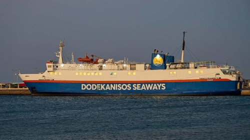 A Dodekanisos Seaways ferry docks at dusk in the harbour by the calm sea, Rhodes Old Town, Rhodes