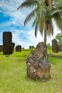 In the foreground ancient stone monolith Stone monolith in the shape of head with unexplained