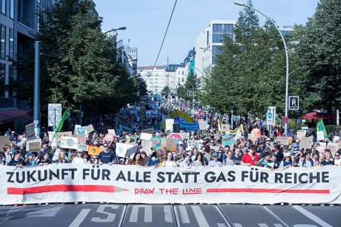Demonstrators with front banner Future for all instead of gas for the rich on Friedrichstraße at