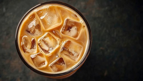 Top-Down View Of Iced Milk Coffee On Black Background: Close-Up Of Refreshing Drink Served Cold And