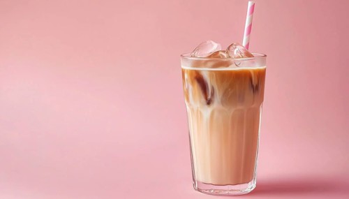Refreshing Pink Glass Of Iced Coffee Milk. Delicious Cold Beverage To Enjoy On A Hot Day. Perfect