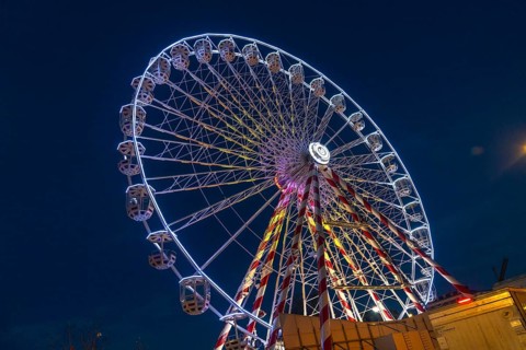 Ferris wheel illuminating the night sky during christmas festivities in bayonne, france, creating a