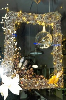 Festive christmas decoration illuminating a shop window in bayonne, france, creating a warm and