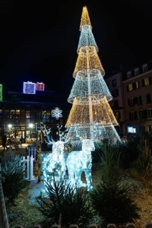 Luminous christmas tree and reindeer decorations create a festive atmosphere in bayonne, france,