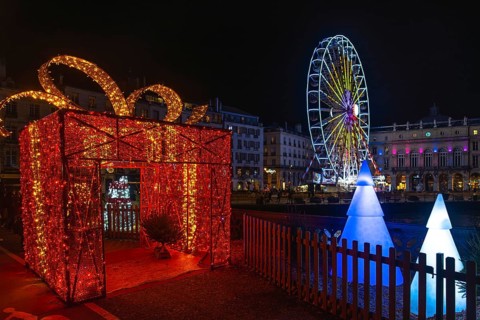 Festive christmas decorations illuminating bayonne's city center at night, creating a magical