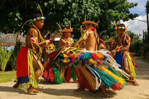 Traditional group of dancers from Yap Island dancing in historical traditional costume with