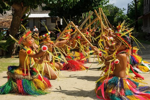 Traditional group of dancers from Yap Island dancing in historical traditional dress traditional