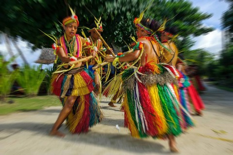 Traditional group of dancers from Yap Island dancing in historical traditional dress traditional
