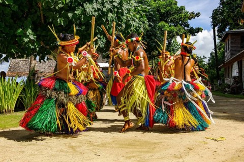 Traditional group of dancers from Yap Island dancing in historical traditional dress traditional