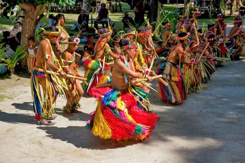 Traditional group of dancers from Yap Island dancing in historical traditional costume headdress