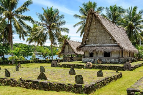 Traditional houses in museum village of Yap Island in front of dance area wonbey for traditional
