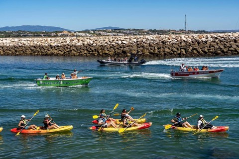 Kayak tours to the rocky coast of Ponta da Piedade, groups of tourists kayak on the sea to the
