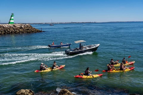 Kayak tours to the rocky coast of Ponta da Piedade, groups of tourists kayak on the sea to the