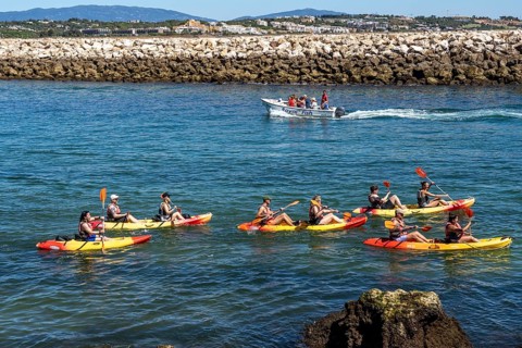 Kayak tours to the rocky coast of Ponta da Piedade, groups of tourists kayak on the sea to the