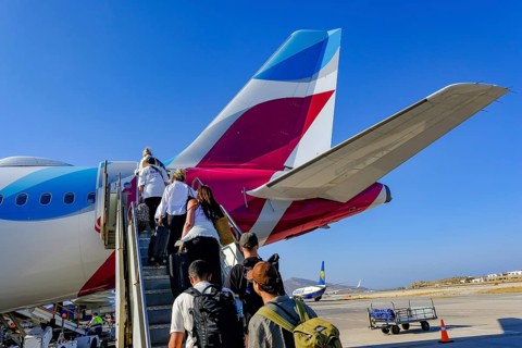 Mykonos, Greece - EUROWINGS. At Mykonos Airport, holidaymakers board a Eurowings aircraft via an