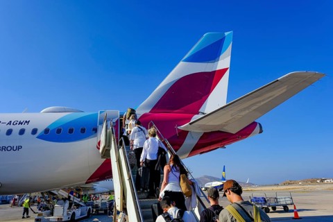 Mykonos, Greece - EUROWINGS. At Mykonos Airport, holidaymakers board a Eurowings aircraft via an