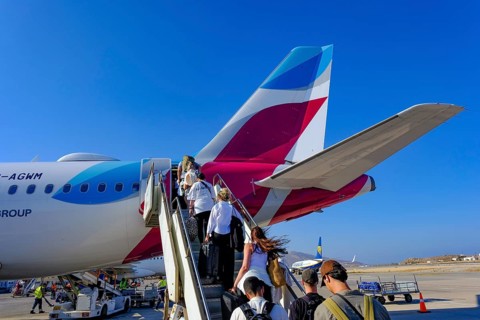 Mykonos, Greece - EUROWINGS. At Mykonos Airport, holidaymakers board a Eurowings aircraft via an
