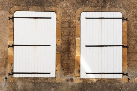 2 white, closed wooden windows, historic house façade, yellow sandstone, Marville, Renaissance