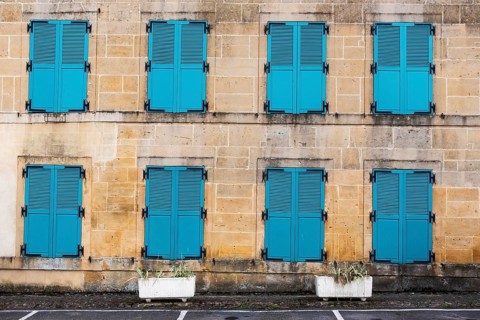 Closed, green shutters, historic house facade, yellow sandstone, Marville, Renaissance village,