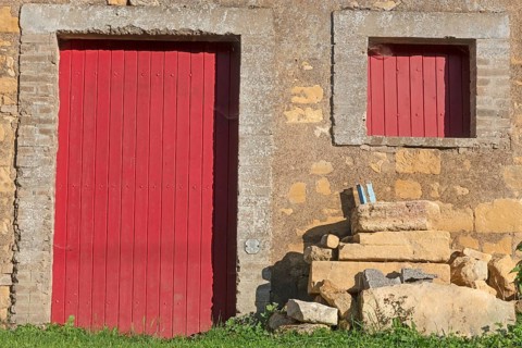 Red door and windows, historic house façade, yellow sandstone, Marville, Renaissance village,