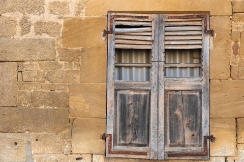 Closed wooden window, historic house facade, yellow sandstone, Marville, Renaissance village,