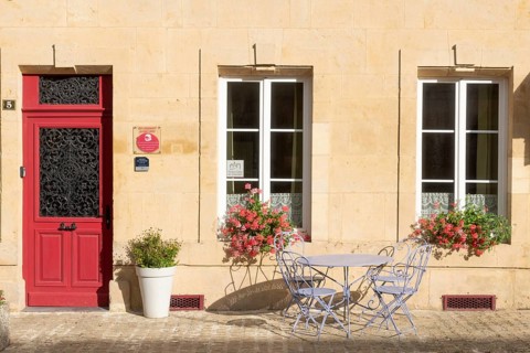 Entrance decorated with flowers, table and chairs, Marville, Renaissance village, Département