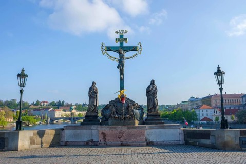 Statuary of the Holy Crucifix and Calvary on Charles Bridge, in Prague, Czech Republic, in sunny