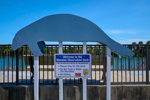 Manatee observation deck with sign under a clear sky, Haulover Canal, Merritt Island National