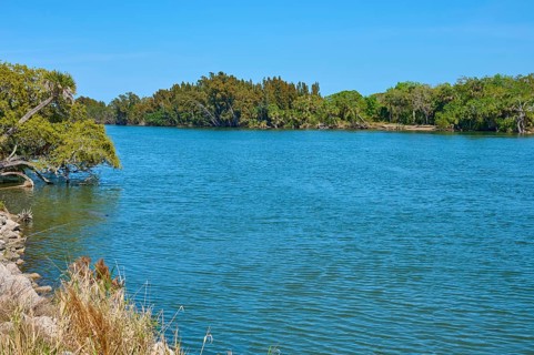 River landscape with serene water and green trees on the banks, Haulover Canal, Merritt Island