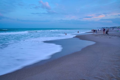 Wave scene on the beach in the evening with people in the background, Cocoa Beach, Port Canaveral,
