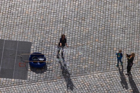 View from the lantern of the Church of Our Lady to the Neumarkt with street artist who delights