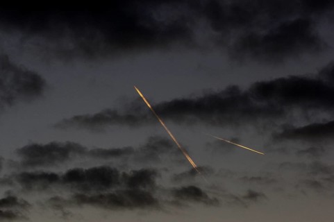 Contrails from passenger aircraft in the evening sky over Berlin