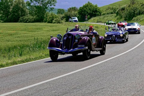 A red classic car leads a group of classic cars on a country road, classic car, car race, Mille